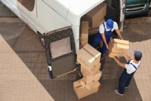 Male,Movers,Unloading,Boxes,From,Van,Outdoors,,Above,View